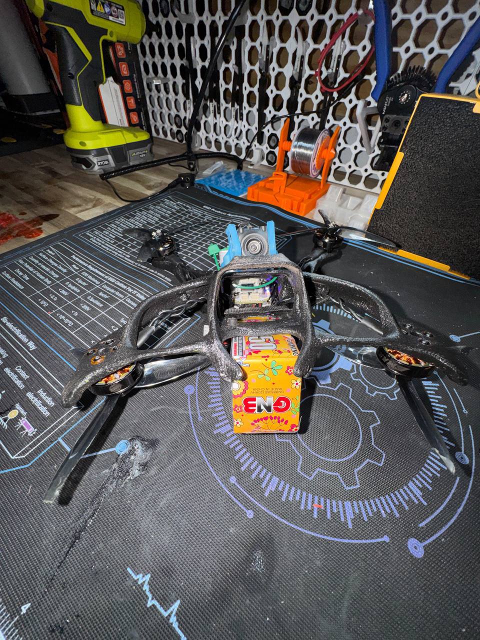 3D printed freestyle quad with GNB battery on solder mat